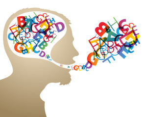 Abstract speaker silhouette with colorful letters in the head and mouth